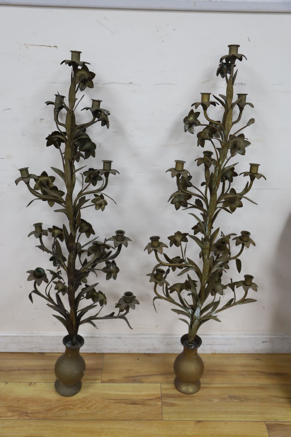 A pair of tall brass candelabra